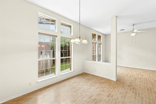 1212 Dove Cir, Cedar Park, TX 78613 - unfurnished dining area with a chandelier, wood finished floors, and a ceiling fan