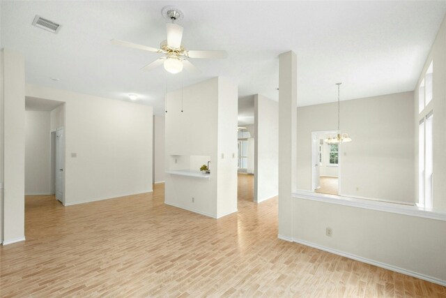 1212 Dove Cir, Cedar Park, TX 78613 - empty room featuring light wood-style floors, ceiling fan, and a chandelier