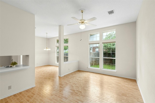 1212 Dove Cir, Cedar Park, TX 78613 - empty room featuring a ceiling fan, a chandelier, and light wood finished floors