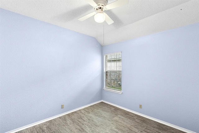1212 Dove Cir, Cedar Park, TX 78613 - spare room with wood finished floors, a ceiling fan, vaulted ceiling, and a textured ceiling