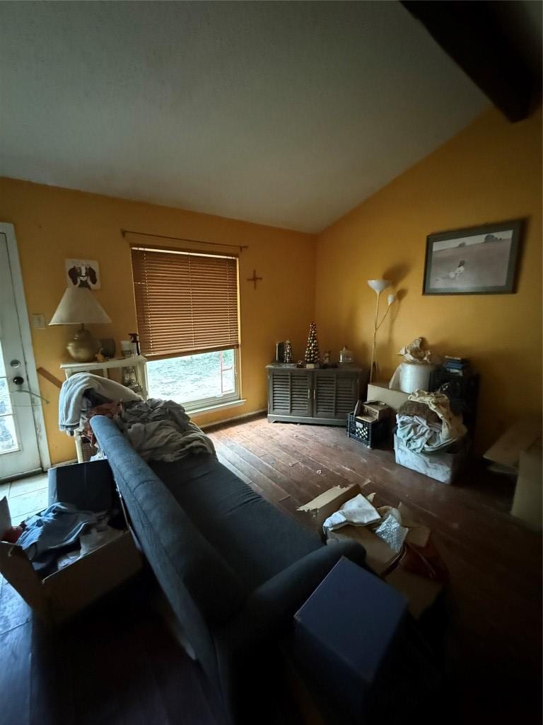 1204 Dunstan Dr, Austin, TX 78745 - living room featuring vaulted ceiling and wood finished floors