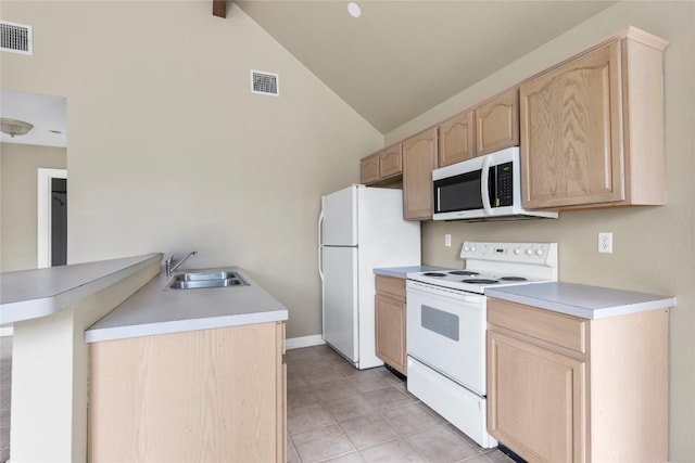 1109 Sherrill Ln, Lexington, TX 78947 - kitchen with light brown cabinetry, white appliances, a peninsula, light tile patterned floors, and light countertops