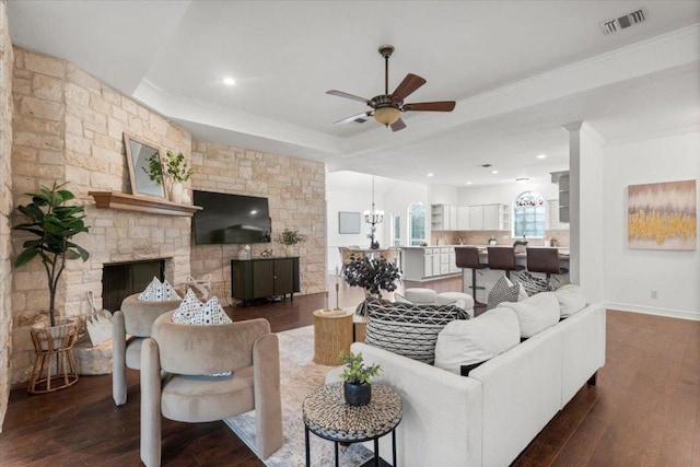 1109 Sherrill Ln, Lexington, TX 78947 - living room with crown molding, ceiling fan, wood finished floors, and a stone fireplace