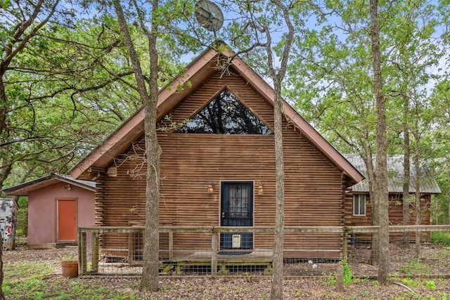 111 Sendero Blvd, Cedar Creek, TX 78612 - view of side of home with log exterior and a shed