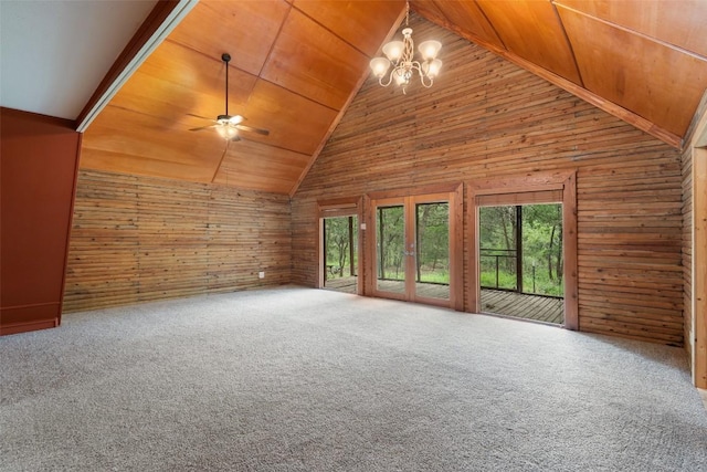111 Sendero Blvd, Cedar Creek, TX 78612 - unfurnished living room featuring wooden ceiling, wood walls, a ceiling fan, a chandelier, and carpet floors