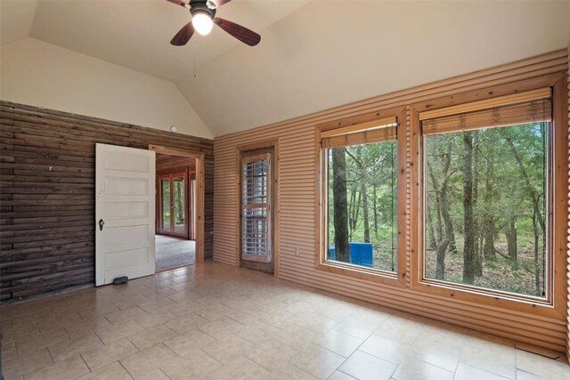 111 Sendero Blvd, Cedar Creek, TX 78612 - empty room with vaulted ceiling, a ceiling fan, and tile patterned flooring