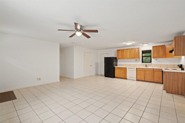 111 Sendero Blvd, Cedar Creek, TX 78612 - kitchen with freestanding refrigerator, dishwasher, light countertops, ceiling fan, and electric stove