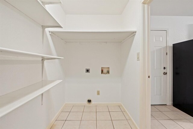 111 Sendero Blvd, Cedar Creek, TX 78612 - laundry room with light tile patterned floors, hookup for an electric dryer, and hookup for a washing machine