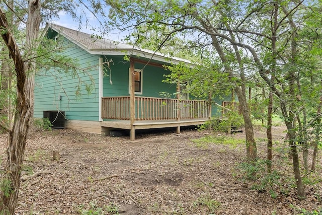 111 Sendero Blvd, Cedar Creek, TX 78612 - view of side of home featuring a deck and a metal roof