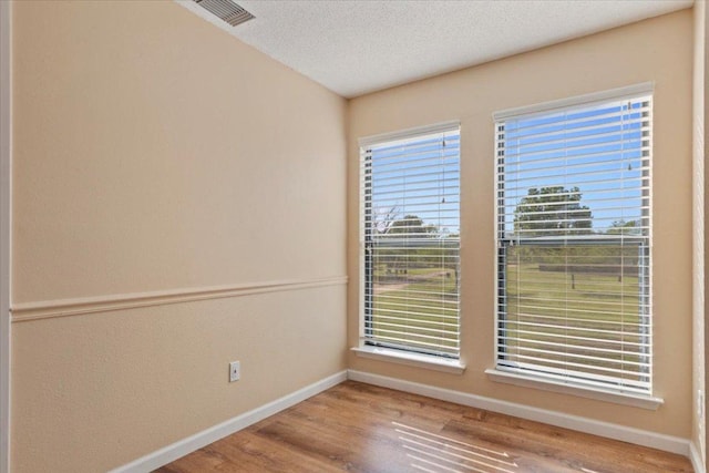 10616 Mellow Meadows Dr Unit 21C, Austin, TX 78750 - empty room with wood finished floors and a textured ceiling