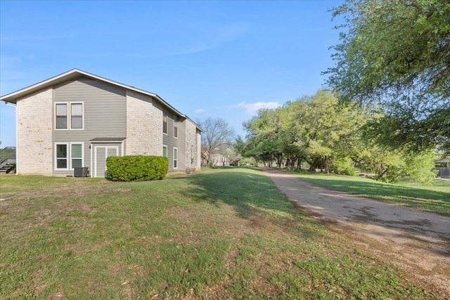 10616 Mellow Meadows Dr Unit 21C, Austin, TX 78750 - view of side of home featuring a yard and a central air condition unit