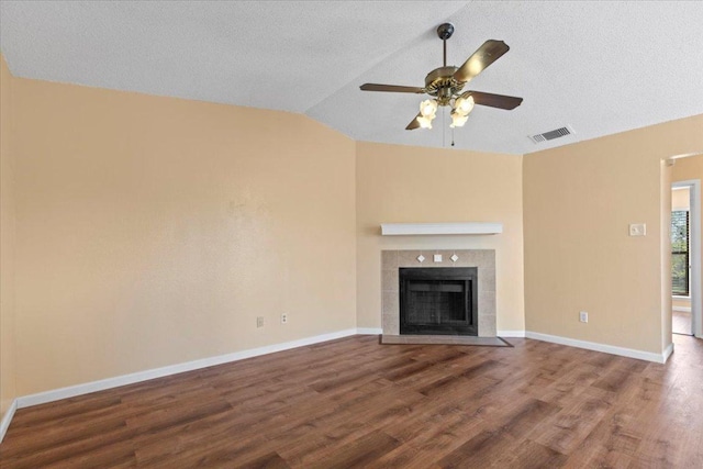 10616 Mellow Meadows Dr Unit 21C, Austin, TX 78750 - unfurnished living room featuring wood finished floors, vaulted ceiling, a ceiling fan, and a fireplace