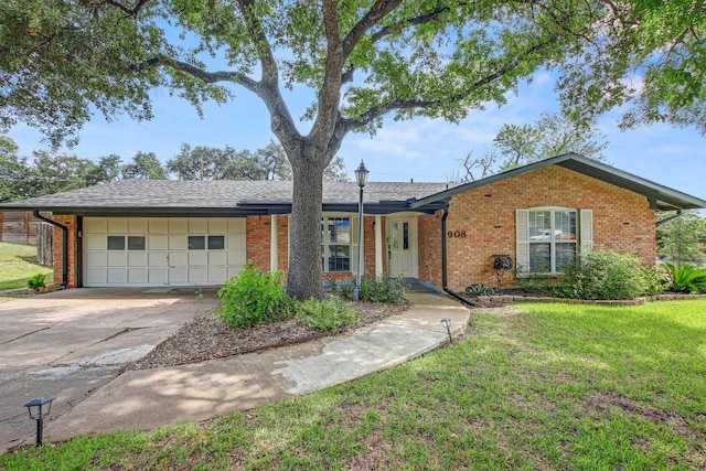 908 Hollybluff St, Austin, TX 78753 - ranch-style home with brick siding, concrete driveway, a garage, and a front yard