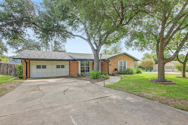 908 Hollybluff St, Austin, TX 78753 - view of front of house with a garage, brick siding, and driveway