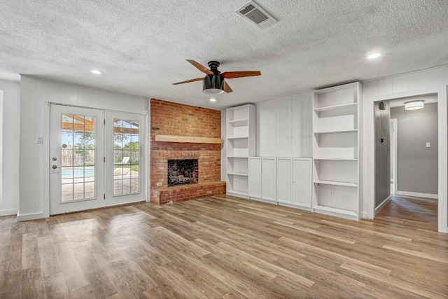 908 Hollybluff St, Austin, TX 78753 - unfurnished living room with a textured ceiling, ceiling fan, wood finished floors, recessed lighting, and a fireplace