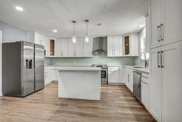 908 Hollybluff St, Austin, TX 78753 - kitchen with appliances with stainless steel finishes, wall chimney range hood, light countertops, decorative backsplash, and white cabinets