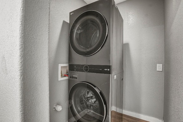 908 Hollybluff St, Austin, TX 78753 - laundry area with stacked washer and clothes dryer and a textured wall