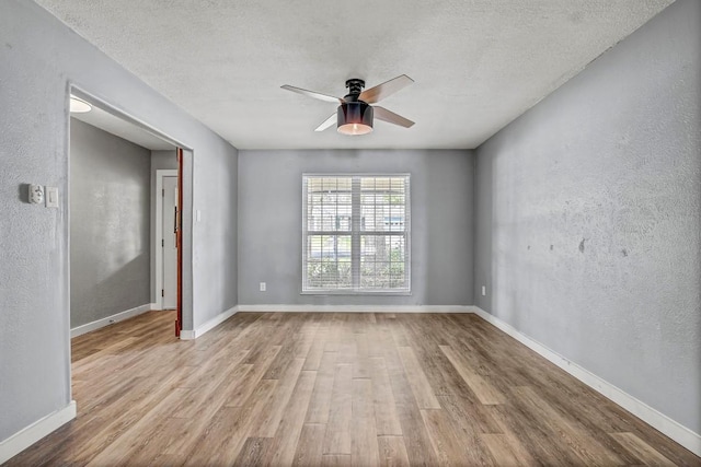 908 Hollybluff St, Austin, TX 78753 - empty room featuring wood finished floors, ceiling fan, a textured ceiling, and a textured wall