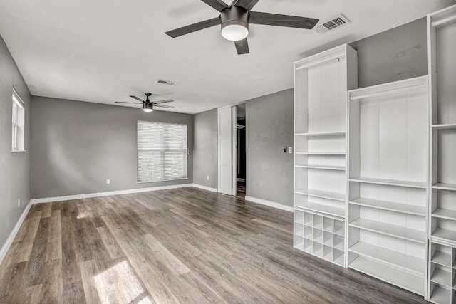 908 Hollybluff St, Austin, TX 78753 - unfurnished living room featuring ceiling fan, wood finished floors, and healthy amount of natural light