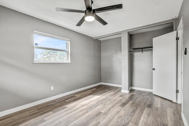 908 Hollybluff St, Austin, TX 78753 - unfurnished bedroom featuring wood finished floors, a closet, and a ceiling fan