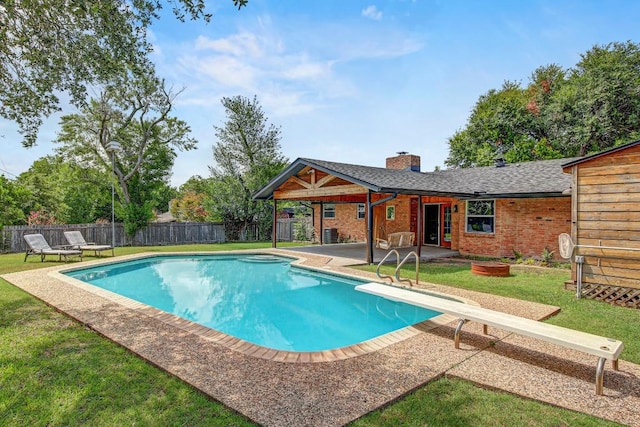 908 Hollybluff St, Austin, TX 78753 - view of swimming pool featuring a diving board, a patio, and a fenced backyard