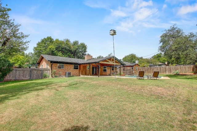 908 Hollybluff St, Austin, TX 78753 - back of property with a chimney, a fenced backyard, and brick siding