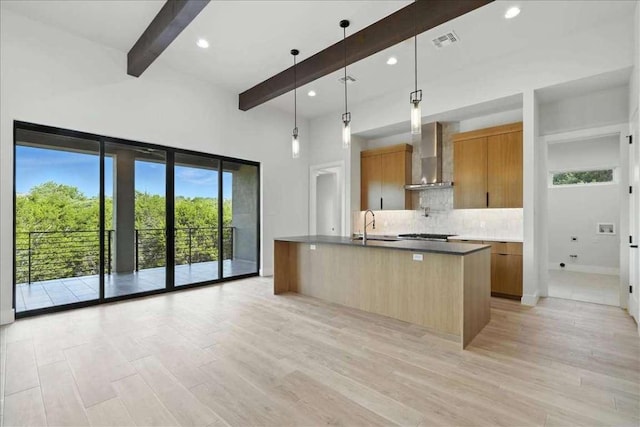 512 Cowal Dr S, Spicewood, TX 78669 - kitchen with wall chimney exhaust hood, beamed ceiling, backsplash, modern cabinets, and light wood-type flooring