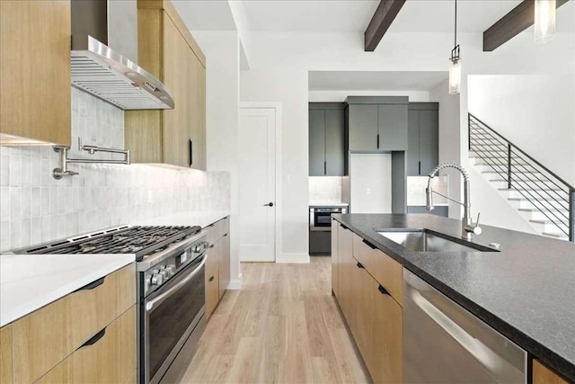 512 Cowal Dr S, Spicewood, TX 78669 - kitchen with stainless steel appliances, wall chimney range hood, light wood-style flooring, beamed ceiling, and backsplash