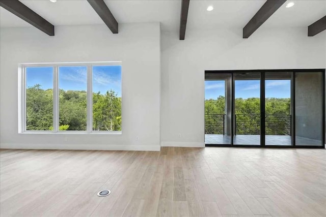 512 Cowal Dr S, Spicewood, TX 78669 - unfurnished room with beamed ceiling, healthy amount of natural light, wood finished floors, and recessed lighting
