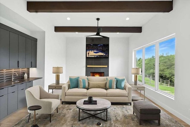 512 Cowal Dr S, Spicewood, TX 78669 - living room with healthy amount of natural light, beam ceiling, light wood-style floors, a fireplace, and recessed lighting