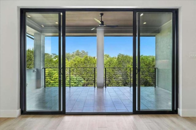 512 Cowal Dr S, Spicewood, TX 78669 - entryway featuring wood finished floors, ceiling fan, and expansive windows