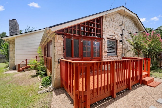 1707 Creek Bend Cir, Round Rock, TX 78681 - rear view of house with stone siding, a wooden deck, and a chimney
