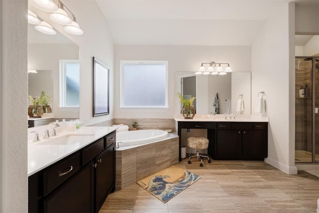 6708 Leonardo Dr, Round Rock, TX 78665 - bathroom featuring two vanities, a shower stall, and a garden tub