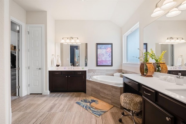 6708 Leonardo Dr, Round Rock, TX 78665 - full bathroom featuring a bath, two vanities, lofted ceiling, and a spacious closet