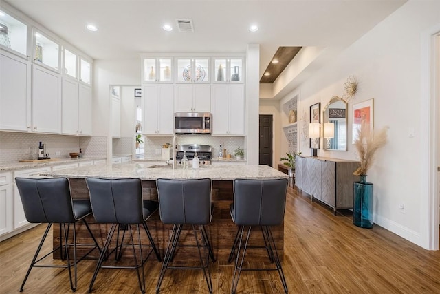 6708 Leonardo Dr, Round Rock, TX 78665 - kitchen with appliances with stainless steel finishes, tasteful backsplash, white cabinets, and recessed lighting