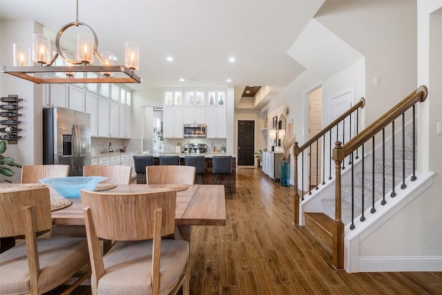 6708 Leonardo Dr, Round Rock, TX 78665 - dining area with dark wood-style flooring, stairs, a chandelier, and recessed lighting