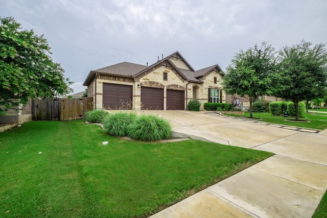 6708 Leonardo Dr, Round Rock, TX 78665 - french country inspired facade featuring a garage, stone siding, and concrete driveway