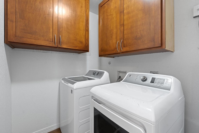 5700 Jain Ln, Austin, TX 78721 - laundry room featuring cabinet space and washer and clothes dryer