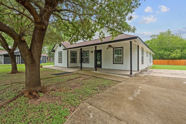 5700 Jain Ln, Austin, TX 78721 - single story home with ceiling fan, a shingled roof, and a porch