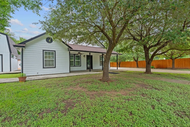 5700 Jain Ln, Austin, TX 78721 - view of front facade with ceiling fan, a patio area, and an attached carport