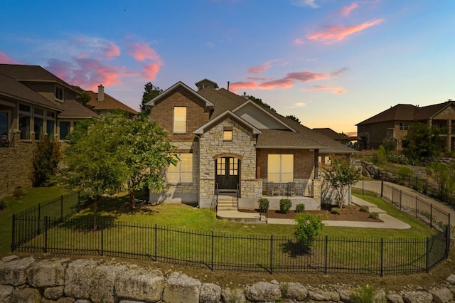 2304 Arroyo Grande, Leander, TX 78641 - view of front of property featuring stone siding and a fenced front yard