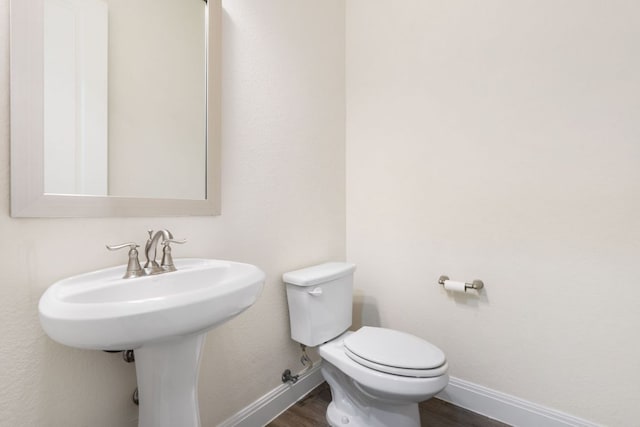 2304 Arroyo Grande, Leander, TX 78641 - bathroom featuring baseboards and wood finished floors