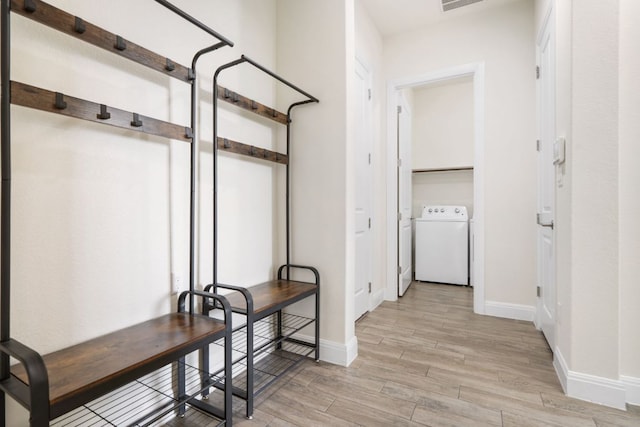 2304 Arroyo Grande, Leander, TX 78641 - corridor with light wood-style flooring and washer and dryer