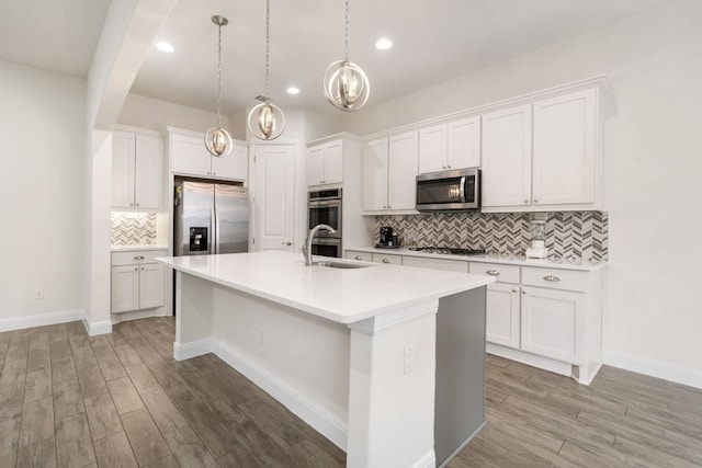 2304 Arroyo Grande, Leander, TX 78641 - kitchen featuring stainless steel appliances, a center island with sink, light wood-style floors, backsplash, and recessed lighting