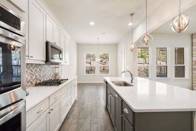2304 Arroyo Grande, Leander, TX 78641 - kitchen featuring stainless steel appliances, wood finished floors, healthy amount of natural light, light countertops, and recessed lighting