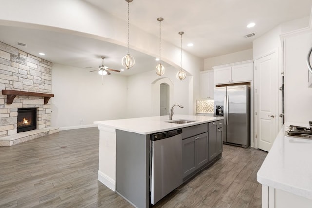 2304 Arroyo Grande, Leander, TX 78641 - kitchen with appliances with stainless steel finishes, arched walkways, open floor plan, a ceiling fan, and light countertops