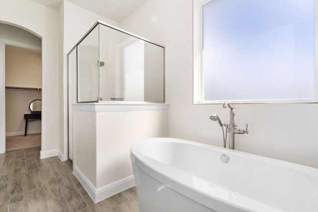 2304 Arroyo Grande, Leander, TX 78641 - full bath with a freestanding tub, a stall shower, a spacious closet, and wood finished floors