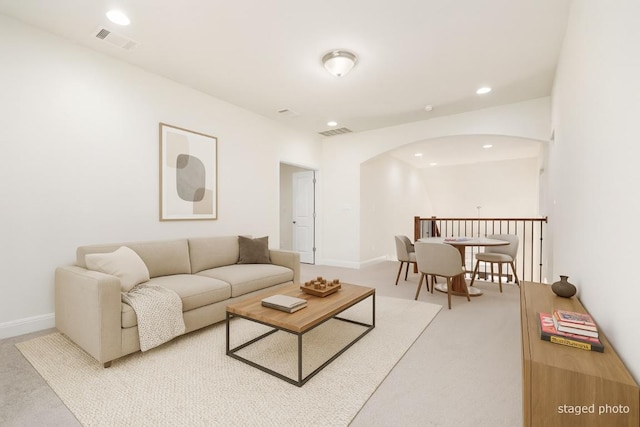 2304 Arroyo Grande, Leander, TX 78641 - carpeted living room with arched walkways and recessed lighting