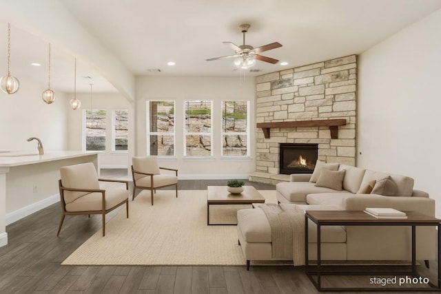 2304 Arroyo Grande, Leander, TX 78641 - living area with ceiling fan, dark wood-style floors, recessed lighting, and a stone fireplace