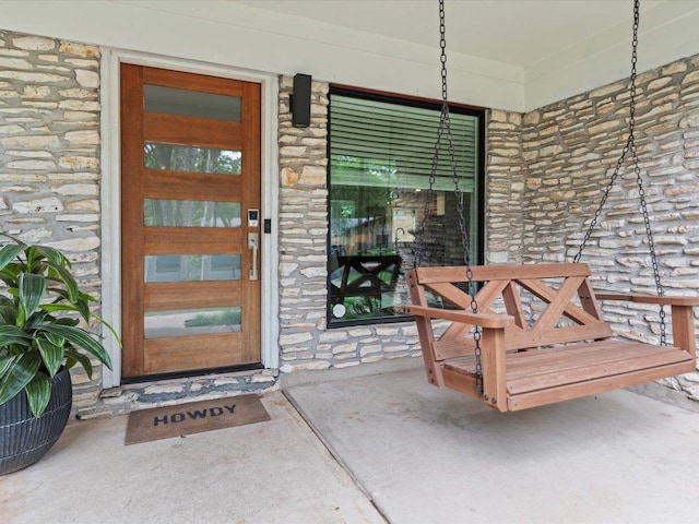 1907 Parkside Ln, Austin, TX 78745 - doorway to property featuring stone siding and covered porch